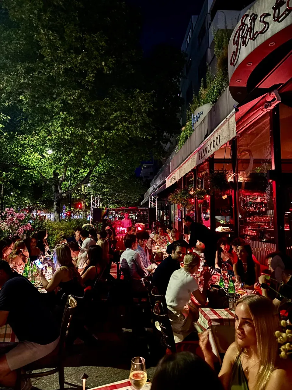 Francucci's packed terrace on Kurfürstendamm at night, a DJ playing at the end of the long table
