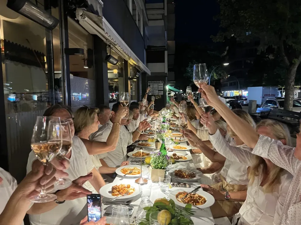 A party at a long table on Francucci’s terrace in the evening